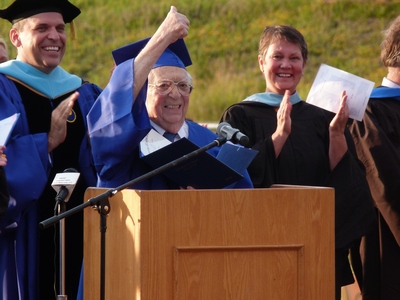 Fred Voss gives thumbs up after receiving high school diploma